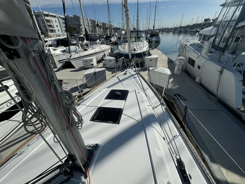 Slide: The Image of 2021 Beneteau Oceanis 35.1 sailboat docked at a marina, surrounded by other boats. - 19