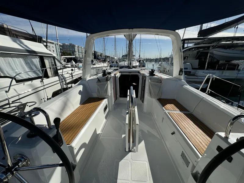 Slide: The Image of Beneteau Oceanis 35.1 sailboat cockpit, 2021 model, docked in a marina with wooden seating. - 27