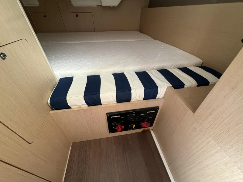 Slide: The Image of Interior cabin of 2021 Beneteau Oceanis 35.1 with striped cushions and wood finish. - 36