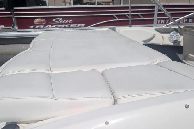 Slide: The Image of 2010 Bayliner 185 Bowrider boat interior with white cushioned seating. - 4