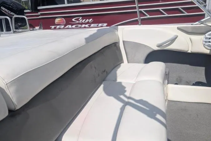 Slide: The Image of 2010 Bayliner 185 Bowrider interior with white seating and gray carpet. - 5