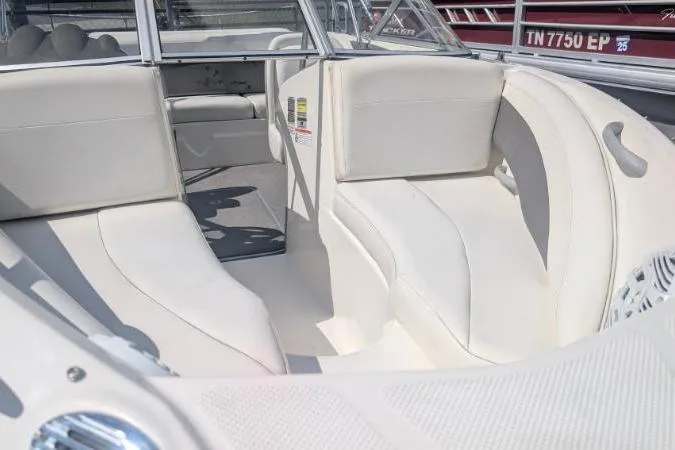 Slide: The Image of 2010 Bayliner 185 Bowrider interior with white seating and open bow layout. - 7