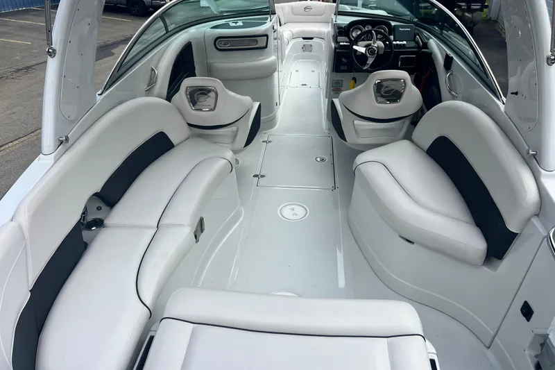 Slide: The Image of Interior of a 2018 Crownline 285 SS boat with white seating and modern dashboard. - 10