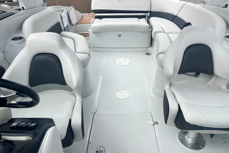 Slide: The Image of 2018 Crownline 285 SS boat interior with white and gray seating, spacious layout. - 11