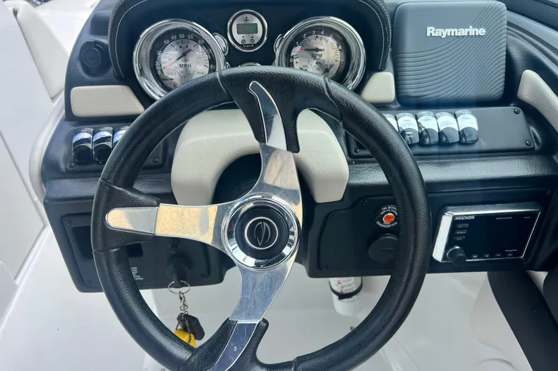 Slide: The Image of Steering wheel and dashboard of 2018 Crownline 285 SS boat with gauges and controls. - 14