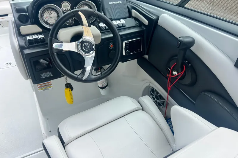 Slide: The Image of 2018 Crownline 285 SS boat cockpit with steering wheel and control panel. - 16