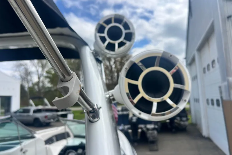 Slide: The Image of Close-up of speakers on a 2018 Crownline 285 SS boat, with a cloudy sky background. - 5