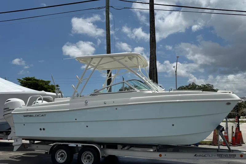 The Image of 2026 World Cat 230 SD boat on trailer under blue sky. - 0