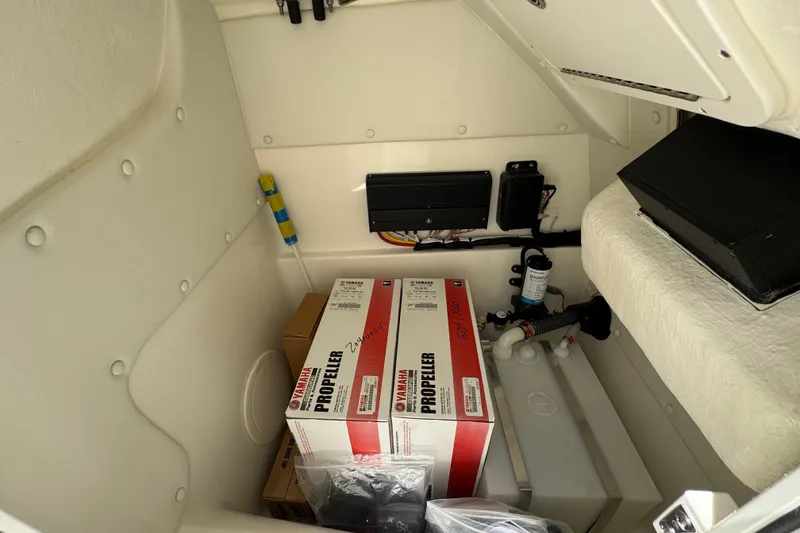 Slide: The Image of Storage compartment of 2026 World Cat 230 SD boat with Yamaha propeller boxes. - 12