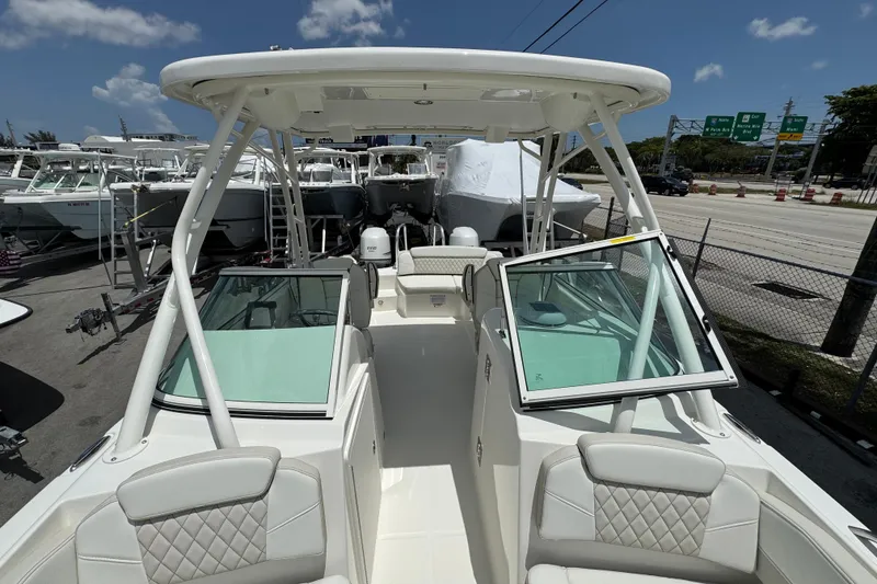 Slide: The Image of 2026 World Cat 230 SD boat with open deck, dual consoles, and modern seating. - 13