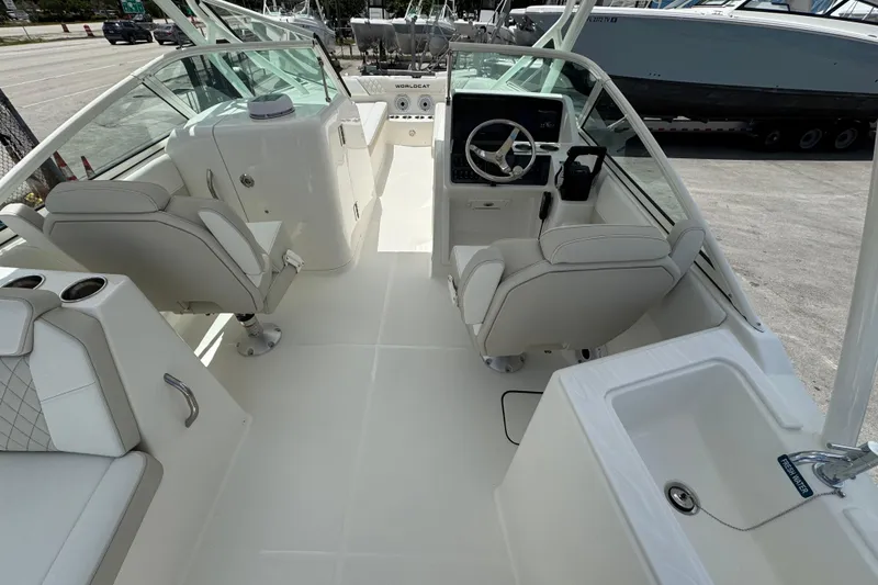Slide: The Image of Interior view of 2026 World Cat 230 SD boat, featuring sleek seating and modern controls. - 15
