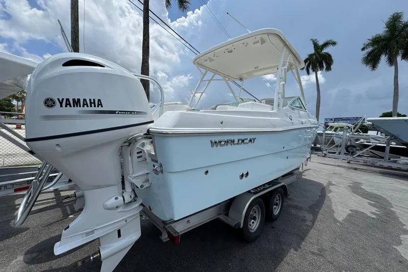 Slide: The Image of 2026 World Cat 230 SD boat with Yamaha engine on trailer, under cloudy sky. - 3