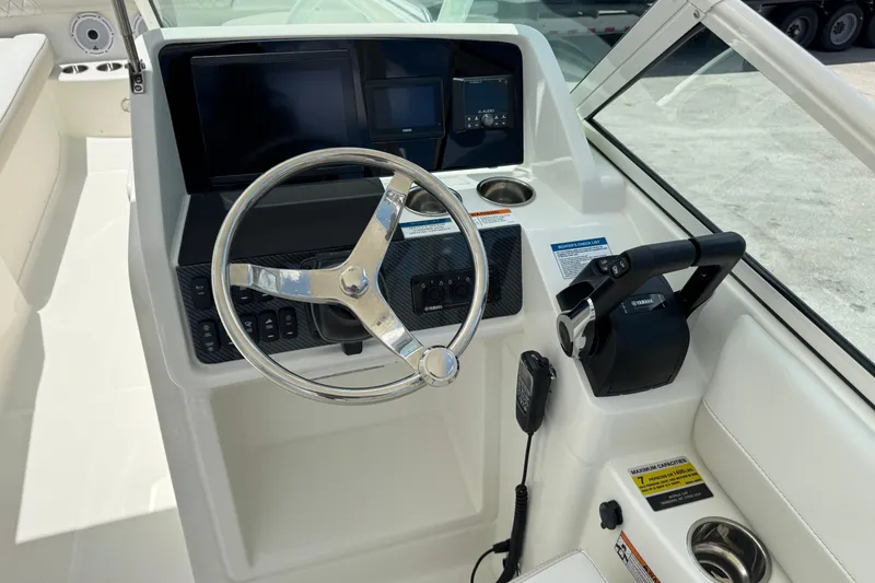 Slide: The Image of Steering console of 2026 World Cat 230 SD boat with modern controls and displays. - 6