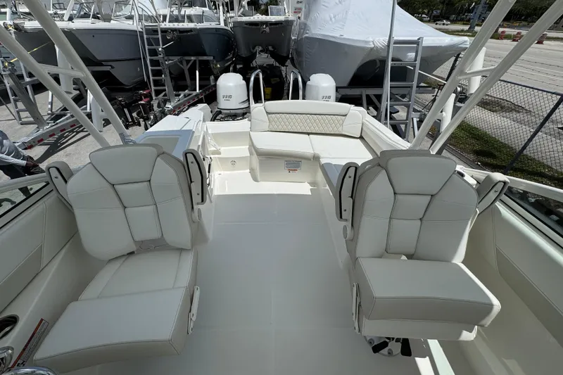 Slide: The Image of 2026 World Cat 230 SD boat interior with white seating and dual engines. - 7