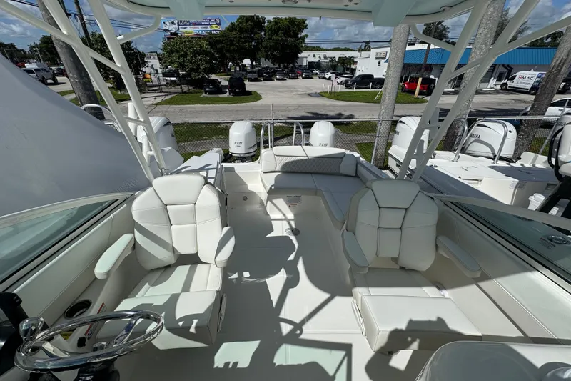 Slide: The Image of 2026 World Cat 230 SD boat interior with white seating and dual engines. - 8
