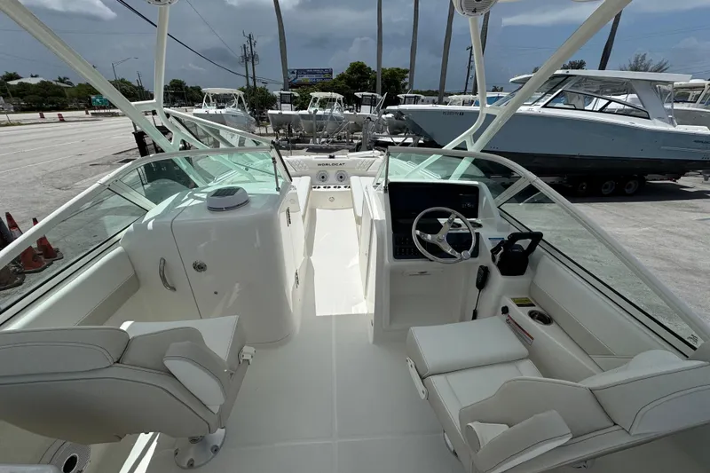 Slide: The Image of Interior view of 2026 World Cat 230 SD boat, featuring modern helm and seating. - 9