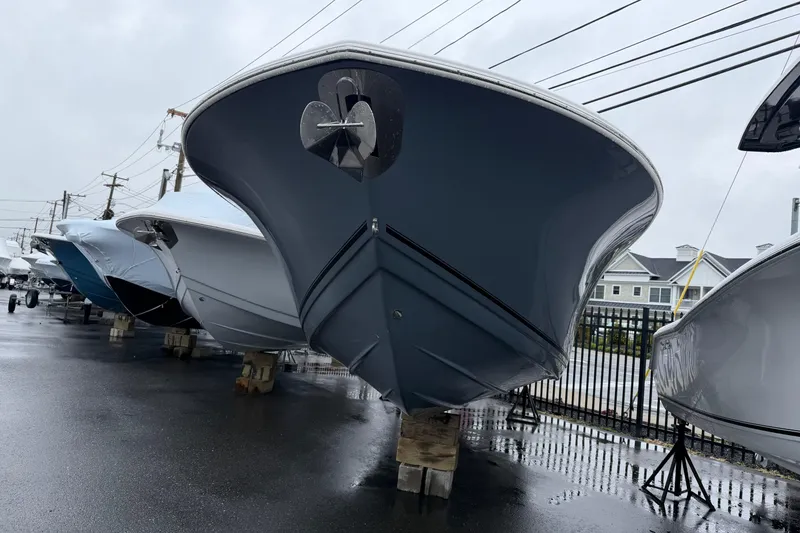 Slide: The Image of 2026 Tidewater 256 LXF boat displayed outdoors on a rainy day. - 2