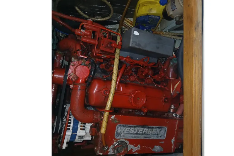 Slide: The Image of Red Westerbeke engine in a 1983 Sabre 34 sailboat, with visible components and accessories. - 10