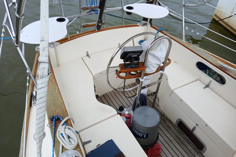 Slide: The Image of Cockpit of a 1983 Sabre 34 sailboat with steering wheel and navigation equipment. - 2