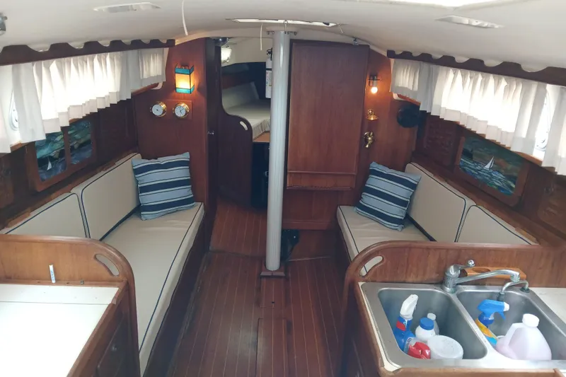 Slide: The Image of Interior of a 1983 Sabre 34 sailboat with cozy seating and nautical decor. - 4