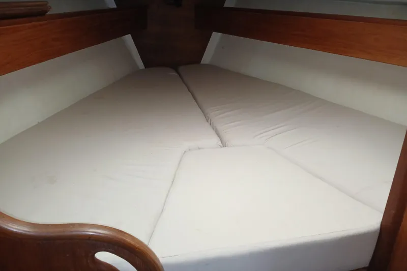 Slide: The Image of Interior cabin view of a 1983 Sabre 34 sailboat with cushioned V-berth. - 7