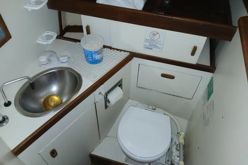 Slide: The Image of Compact bathroom in a 1983 Sabre 34 sailboat with sink and marine toilet. - 8