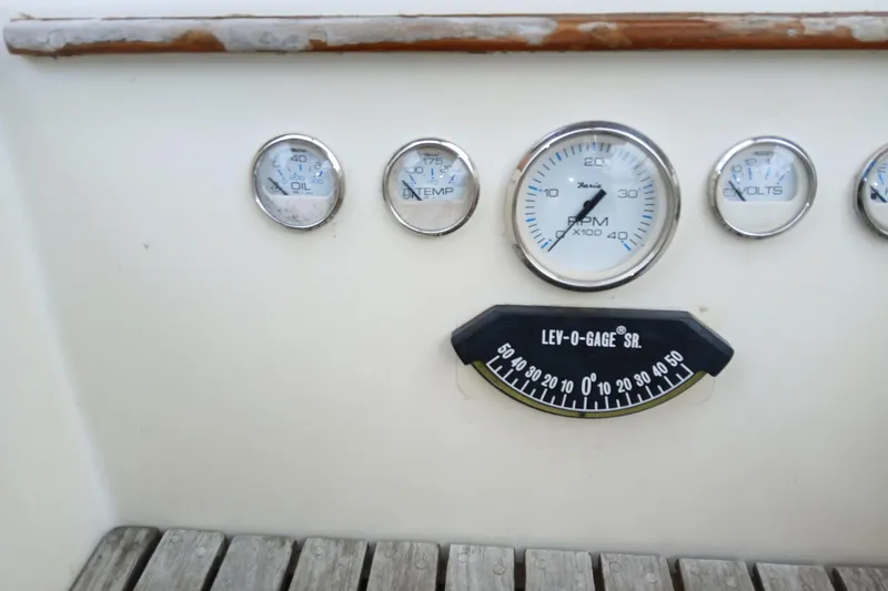 Slide: The Image of 1983 Sabre 34 boat dashboard with gauges for oil, temperature, RPM, and volts. - 9