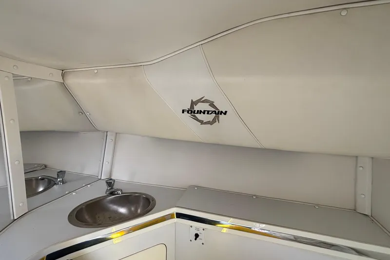 Slide: The Image of Interior of 2007 Fountain 42 Lightning boat with sink and logo on white paneling. - 17