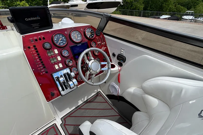 Slide: The Image of Cockpit of 2007 Fountain 42 Lightning boat with red dashboard and Garmin navigation system. - 26