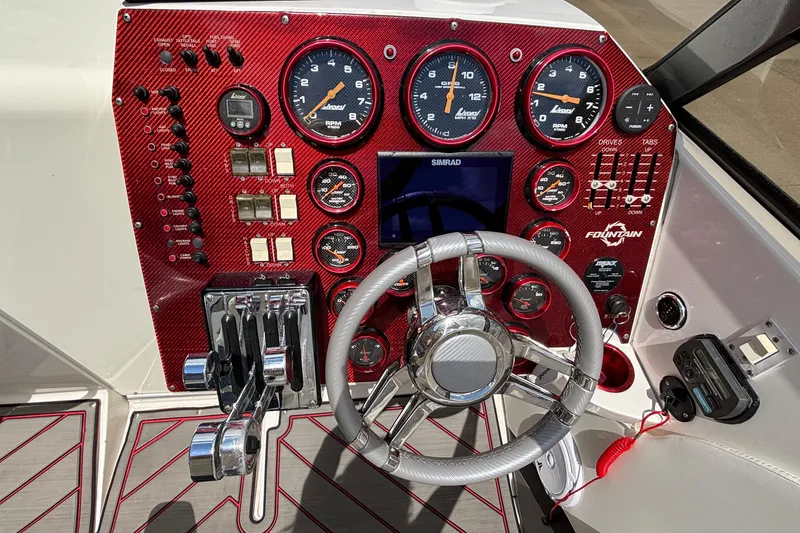 Slide: The Image of Dashboard of a 2007 Fountain 42 Lightning boat with gauges and steering wheel. - 28