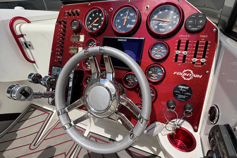 Slide: The Image of Dashboard of a 2007 Fountain 42 Lightning boat with red accents and multiple gauges. - 29