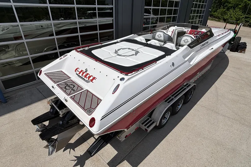 Slide: The Image of 2007 Fountain 42 Lightning speedboat with red and white design, parked on a trailer. - 3