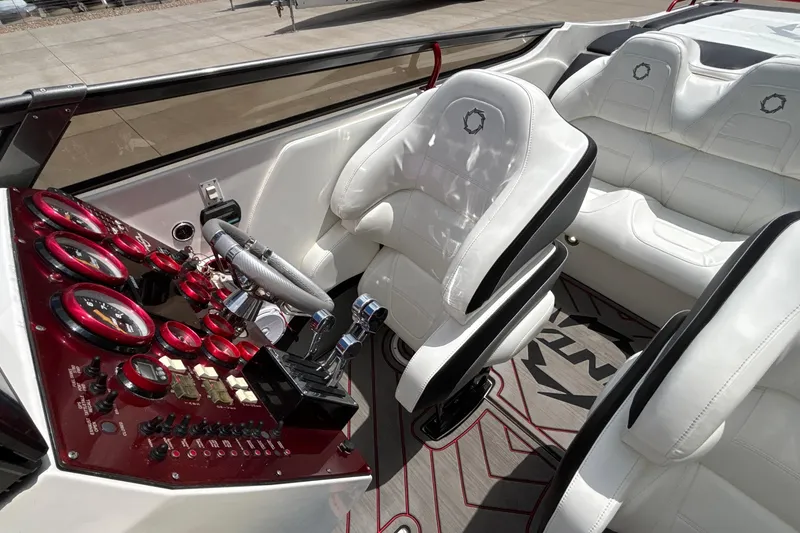 Slide: The Image of Interior of a 2007 Fountain 42 Lightning boat with white seats and red dashboard gauges. - 35