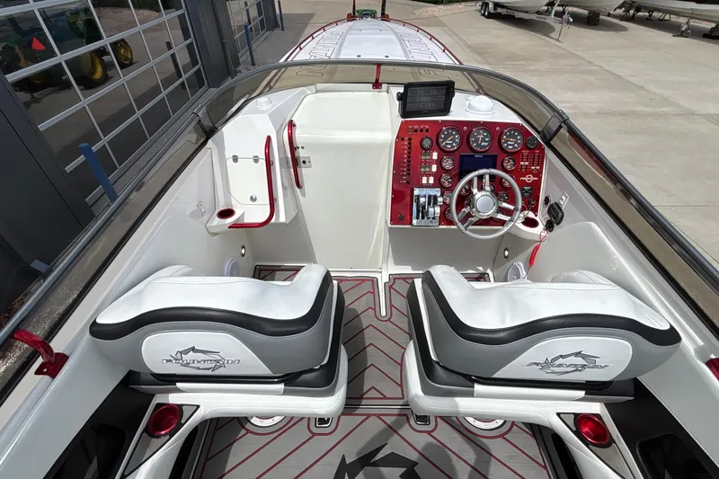 Slide: The Image of 2007 Fountain 42 Lightning boat cockpit with dual seats and red dashboard controls. - 37
