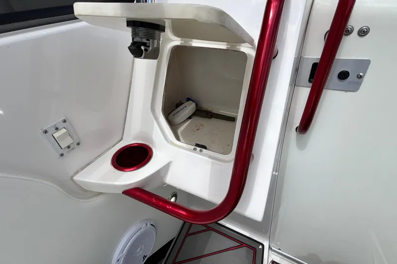 Slide: The Image of Interior detail of a 2007 Fountain 42 Lightning boat with red accents and storage compartment. - 38