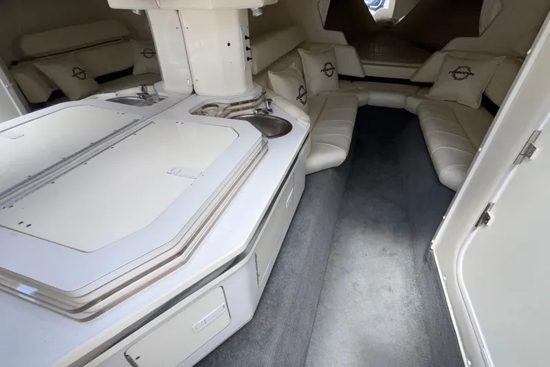 Slide: The Image of Interior of a 2007 Fountain 42 Lightning boat with white seating and compact kitchenette. - 41