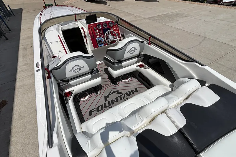 Slide: The Image of 2007 Fountain 42 Lightning boat interior with sleek white and black seating, red dashboard accents. - 6