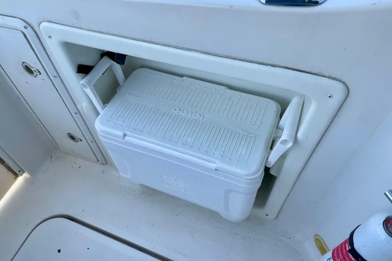 Slide: The Image of White cooler stored on a 2000 Monterey 302 Cruiser boat deck compartment. - 13