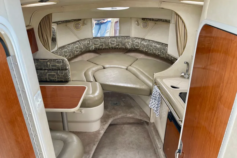 Slide: The Image of Interior of a 2000 Monterey 302 Cruiser boat with seating and kitchenette. - 14