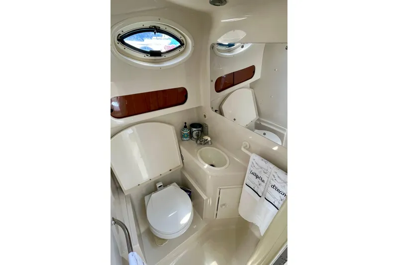 Slide: The Image of Bathroom interior of a 2000 Monterey 302 Cruiser boat, featuring a compact design. - 15