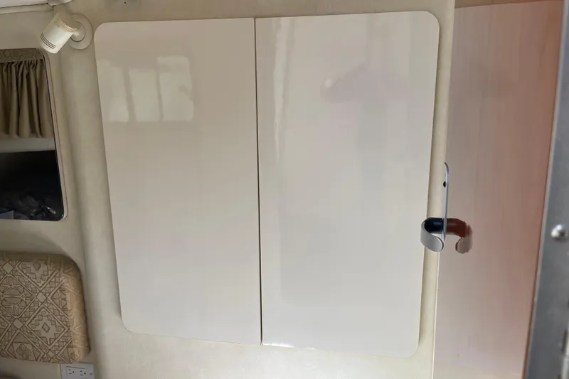 Slide: The Image of Interior of a 2000 Monterey 302 Cruiser with white cabinet doors. - 16
