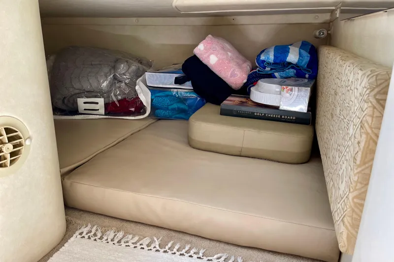 Slide: The Image of Storage area in a 2000 Monterey 302 Cruiser with cushions and assorted items. - 17
