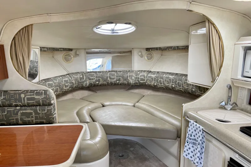Slide: The Image of Interior of a 2000 Monterey 302 Cruiser with cozy seating and kitchenette. - 18