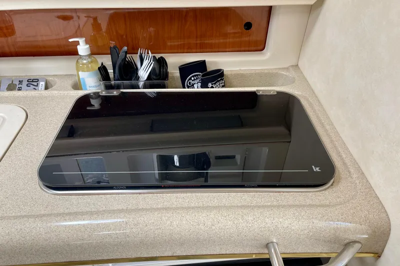 Slide: The Image of Kitchen area of a 2000 Monterey 302 Cruiser with stove and utensils. - 22