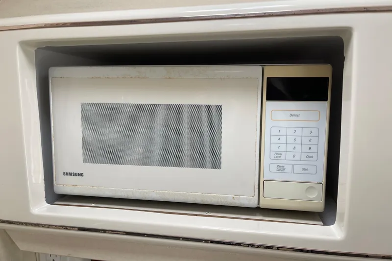 Slide: The Image of Samsung microwave in a 2000 Monterey 302 Cruiser kitchen setup. - 26