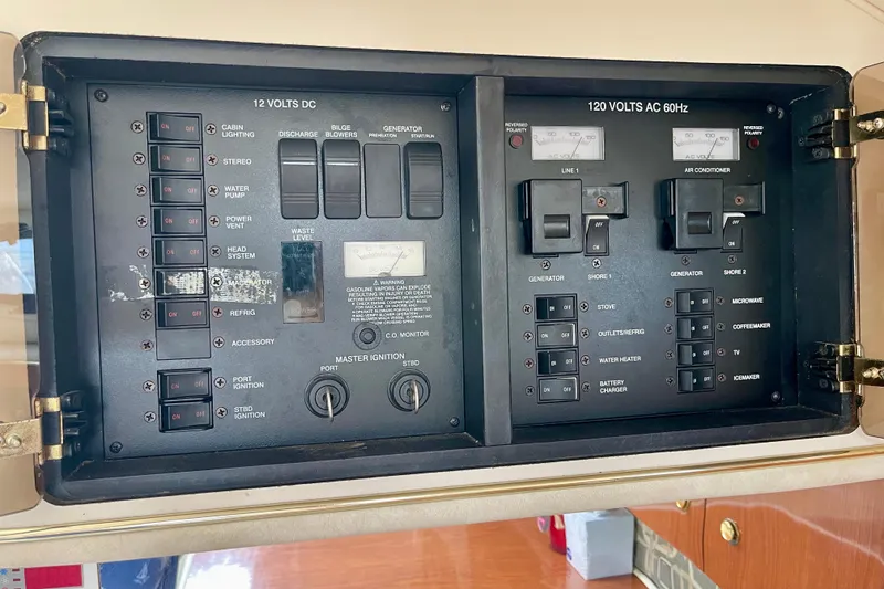 Slide: The Image of Electrical control panel of a 2000 Monterey 302 Cruiser boat, featuring switches and gauges. - 28