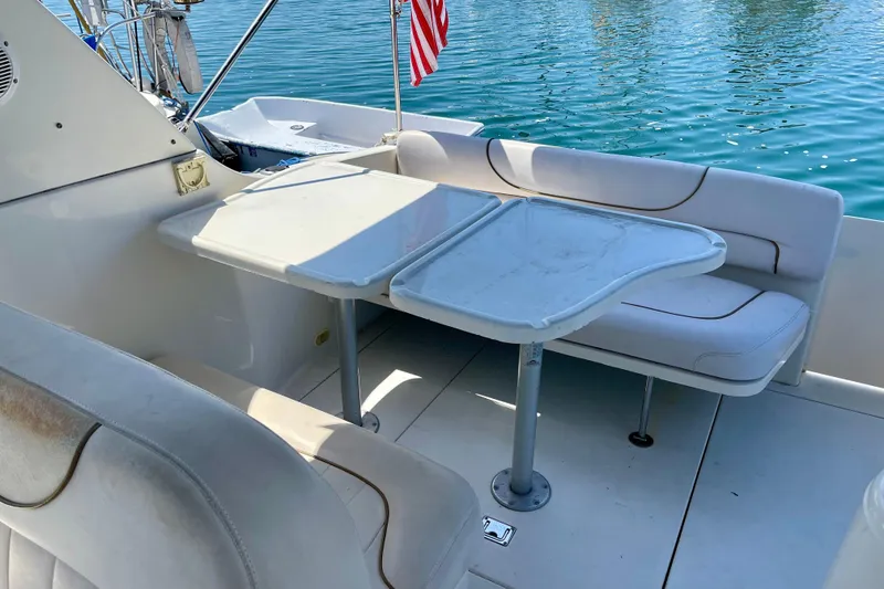 Slide: The Image of Interior of 2000 Monterey 302 Cruiser with seating and table, overlooking water. - 3