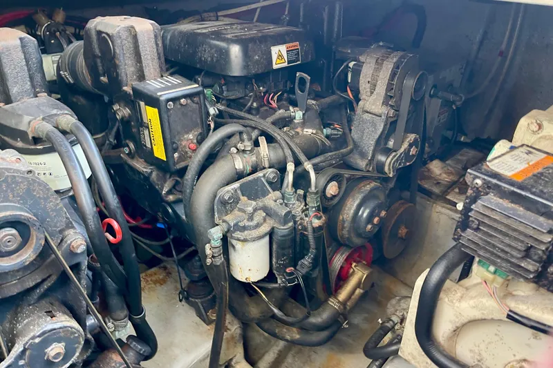 Slide: The Image of Engine compartment of a 2000 Monterey 302 Cruiser boat, showcasing mechanical components. - 31
