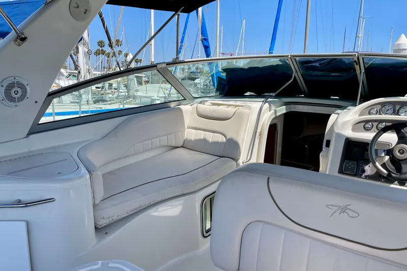 Slide: The Image of Interior view of a 2000 Monterey 302 Cruiser boat with white seating and dashboard. - 7