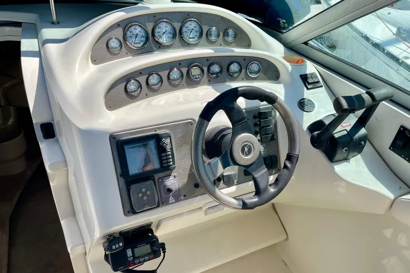 Slide: The Image of Cockpit of a 2000 Monterey 302 Cruiser with steering wheel and instrument panel. - 9